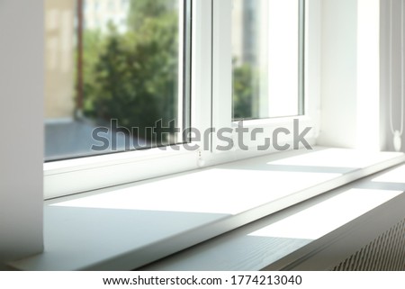 Closeup view of window with empty white sill Royalty-Free Stock Photo #1774213040