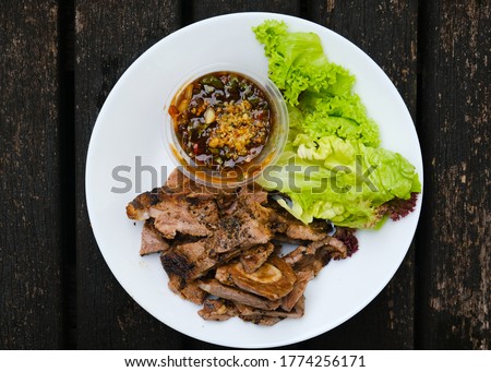 A flatlay picture of famous Malaysian adopt Thai recipe call "daging harimau menangis" in lamb version. Grilled chuck lamb eat with special sweet sour salty spicy sauce