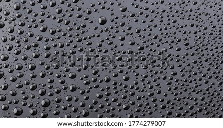 water droplets on glass for background. abstract water drop on black acrylic plate background.