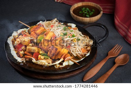 paneer tikka, Tikka paneer served as a starter in wooden sizzler or dish on background Royalty-Free Stock Photo #1774281446