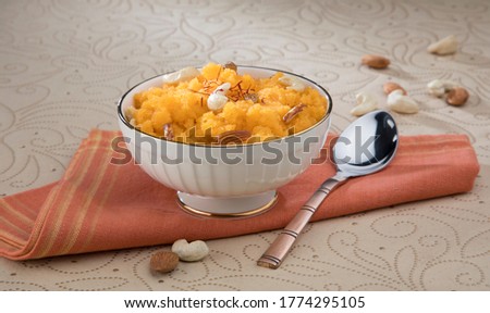 Plain or Saffron flavoured Semolina / Soji Halwa also known as Sweet Rava Sheera OR Shira - Indian festival sweet garnished with dry fruits. Served in a plate or Bowl, selective focus Royalty-Free Stock Photo #1774295105
