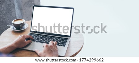 computer mockup image blank screen.hand man work using laptop with white background for advertising,contact business search information on desk at coffee shop.marketing and creative design