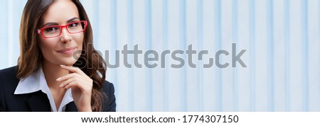 Portrait image of happy smiling businesswoman in black confident style suit and eye glasses, at office. Success in business, job and education concept. Wide size with copy space empty place.