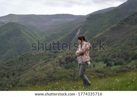 Woman looking from top of hill view, Ligurian Alps, Italy