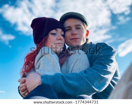 a couple in hats on blue sky background