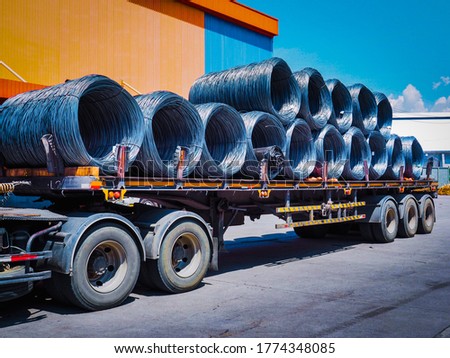 Coils of steel wire rod on truck trailer at industrial zone. Truck receive steel wire rod from warehouse container unstuffing area.  Royalty-Free Stock Photo #1774348085
