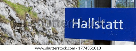 Railway station of Hallstatt with blue guide sign in German. Austria