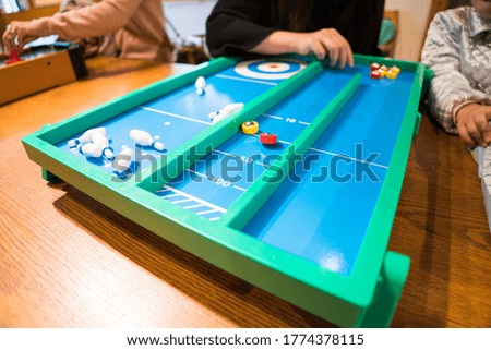 Stay at home with family image, playing classic table game with family.
