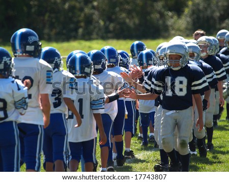 Young American football teams displaying sportsmanship at the end of the game. Royalty-Free Stock Photo #17743807
