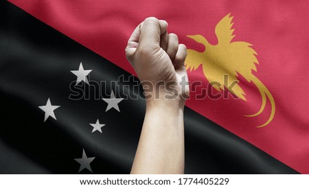 Man Hand Isolated on the background of the flag of Guinea