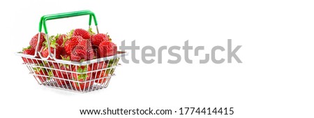 Fresh ripe strawberries in a mini shopping trolley isolated on a white background. Concept of a supermarket, market, or grocery store. copy space.