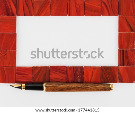 Ceramic frame with pen on white background