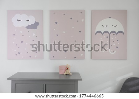 Baby room interior with stylish furniture and cute posters on wall