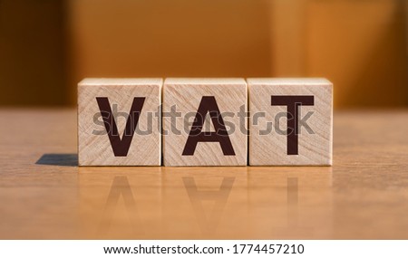Vat on wooden cubes. financial concept background