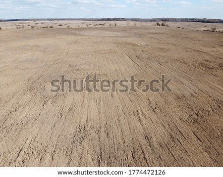 Plowed agricultural field, aerial view. Farmland. Landscape.
