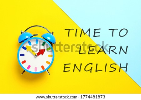 Alarm clock and text Time To Learn English on color background