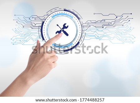 Woman touching icon on virtual screen against light background, closeup. Technical support 