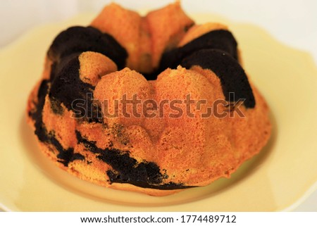 Homemade Vanilla and Chocolate Mini Bundt Cake or Popular as Marble or Marmer Cake. Serve on Cream Cake Stand with Copy Space, Isolated Picture on White Background. Cake in Dutch called "tulband"