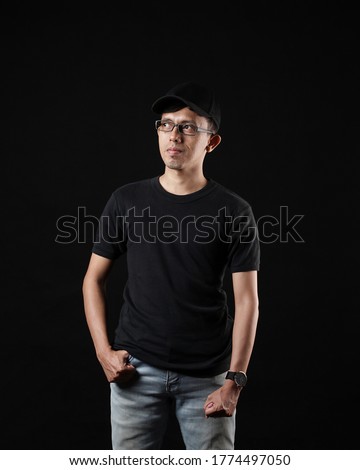 Front portrait with various styles of a young man. A young man with a blank black shirt, front and back views, black background isolated with a clipping point. Design men tshirt templates and mockups