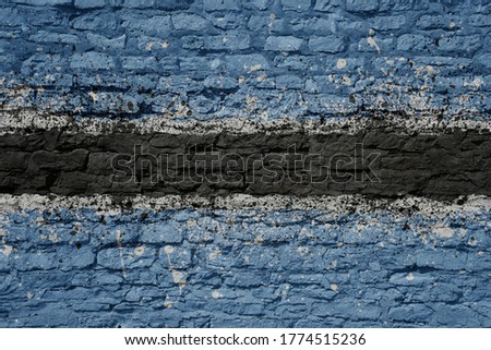 colorful painted big national flag of botswana on a massive old brick wall