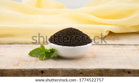 Assam Indian black tea (chai)  Patti Powder Served in White bowl,Red Bowl, Yellow Bowl, Glass bowl. and white background photography