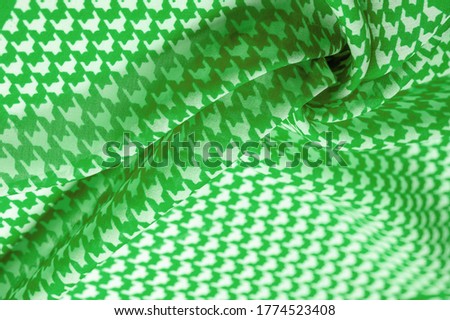 tissue, cloth, texture. Delicate green silk chiffon in vibrant colors with geometric print. Surprisingly light, smooth, sandy to the touch fabric. One of the most elite types of materials.