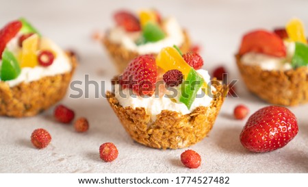 Oatmeal cooked baskets with cottage cheese and fruits. Healthy breakfast oatmeal cups. Romantic food. Cook at home Royalty-Free Stock Photo #1774527482