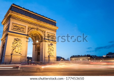 The Arc de Triomphe in Paris, France, at twilight with traffic light trails. Plenty of copy space. Royalty-Free Stock Photo #177453650