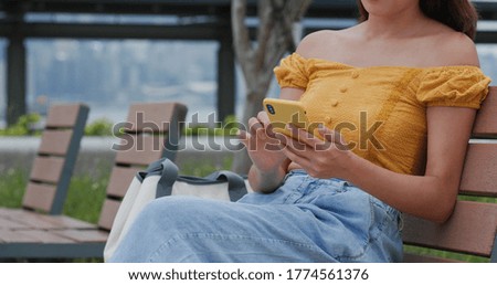 Young woman use of smart phone at park
