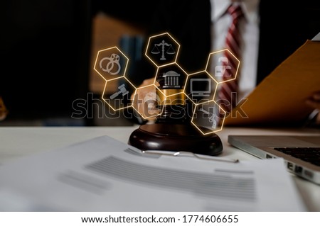 Law and Legal services concept, Good service cooperation, lawyer hands working on table office, Background toned image blurred.