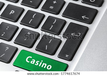 Laptop keyboard with button Casino, closeup. Online games concept