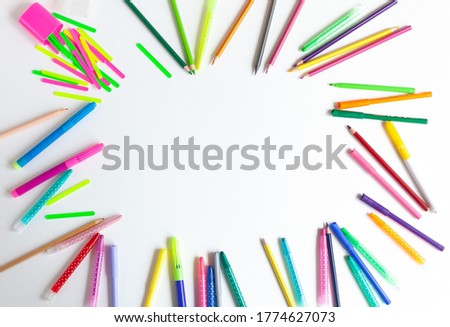 
background for text or greeting card, frame of colored pencils and felt-tip pens