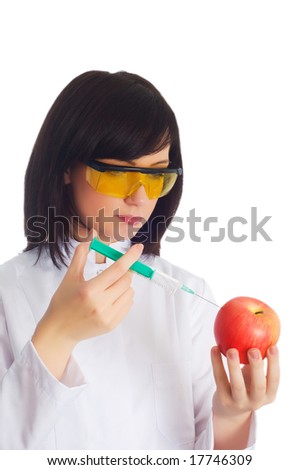 Woman scientist injecting chemicals into apple on white