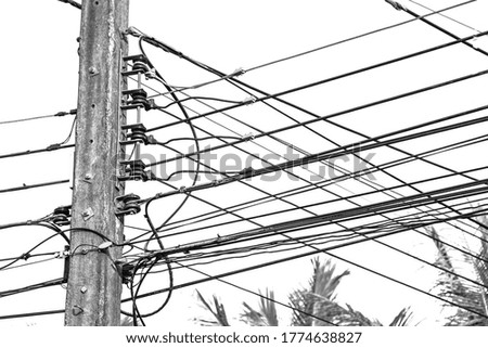 Wire electric in pole it messy and chaotic in black and white background.