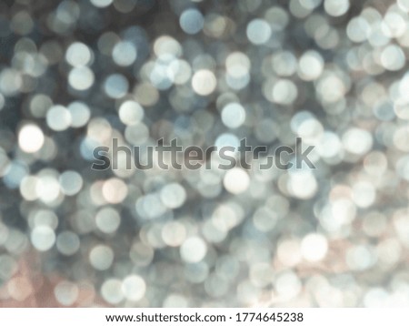 Abstract colorful grey and silver small bokeh Look bright effect texture on black background. glitter vintage lights defocused elegant for cosmetics or celebrate. Sparkling magical dust particles.