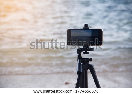 Soft sunlight Close-up Smartphone take a seascape on the beach photo on stand Mobile tripod
