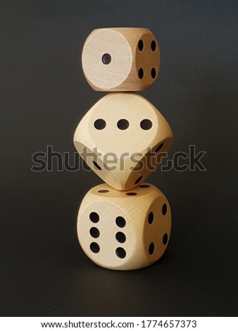 three dice balancing on each other