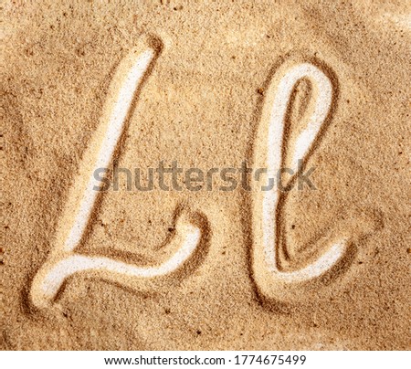 Letter L. English Handwritten Alphabet In The Sand Royalty-Free Stock Photo #1774675499