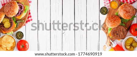 BBQ hamburger double border banner. Top down view table scene over a white wood background. Copy space.