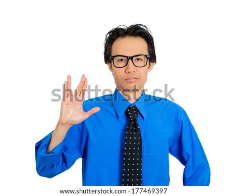 Closeup portrait of young, dorky, geek squad, trekkie man showing vulcan sign to live long and prosper, isolated on white background. Positive emotion facial expression feeling, symbols, attitude