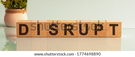 DISRUPT word written on wood block. text on wooden table for your desing, concept.