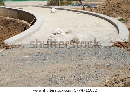 dirty concrete road and soil in construction site stock photo