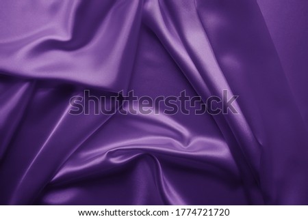Beautiful smooth elegant wavy violet purple satin silk luxury cloth fabric texture, abstract background design. Card or banner.
