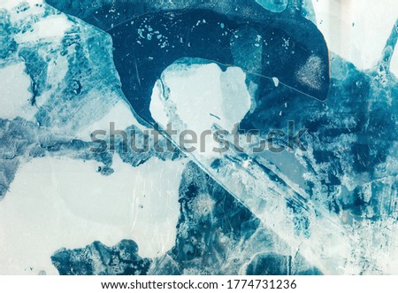 Blue abstract background. Marble pattern. Smeared white acrylic paint with bubbles.