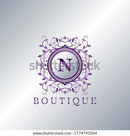 Modern Luxury Boutique Letter N logo. Unique elegance design floral ornament with purple metal circle  frame vector design.