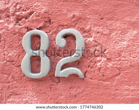 House number 82  weathered cast iron  with number eighty-two