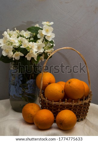 Composition with vase of white jasmine flowers and Fruits in basket isolated on white.
