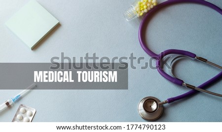 Stethoscope and blank clipboard. Syringe with needle and capsules.