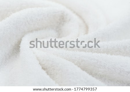 Towel texture closeup. Soft white cotton towel backdrop, fabric background. Terry cloth bath or beach towels. Soft fluffy Textile. Macro, texture  Royalty-Free Stock Photo #1774799357