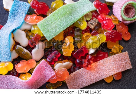 Close-up of assorted colorful jelly candies: gummy bears, penguins and stripes